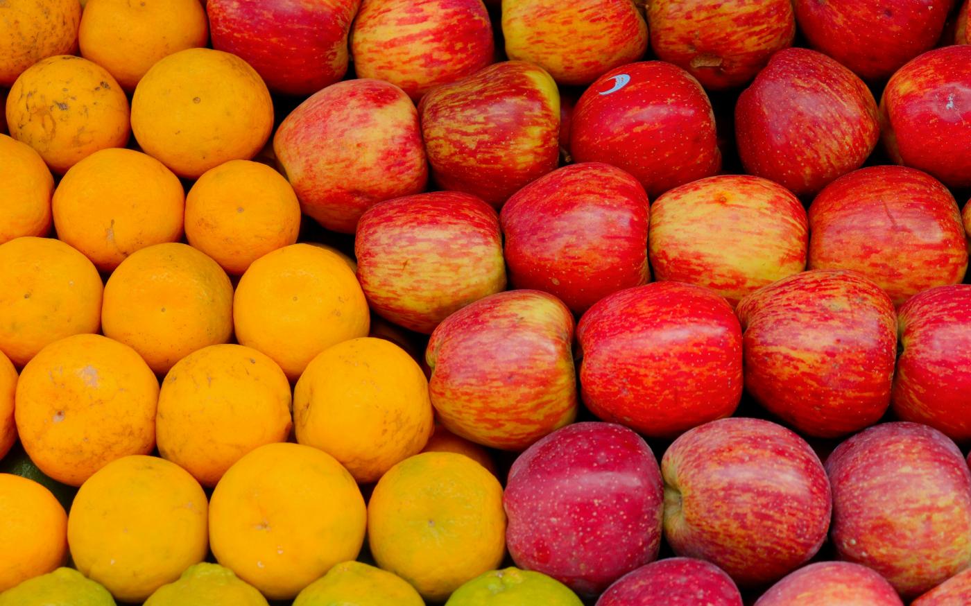 a pile of apples and oranges sitting next to each other by Gowtham AGM courtesy of Unsplash.