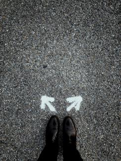 a person standing in the middle of a street by Jon Tyson courtesy of Unsplash.