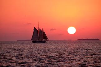 white sailboat on ocean by Bruce Warrington courtesy of Unsplash.