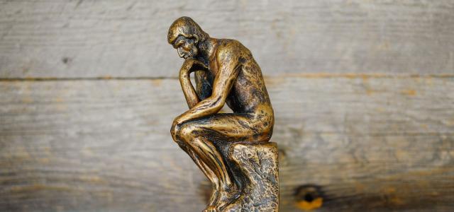 green ceramic statue of a man by Kenny Eliason courtesy of Unsplash.