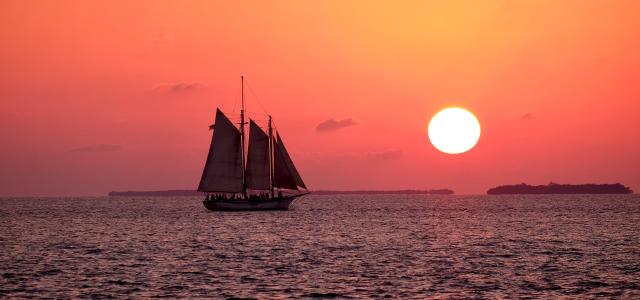 white sailboat on ocean by Bruce Warrington courtesy of Unsplash.